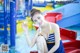 A woman in a blue and yellow bathing suit sitting on a red boat.