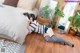 A woman laying on the floor in front of a bed.