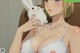 A woman in a white bra holding a white bunny.