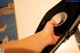 A person holding a roll of tape in their hand.